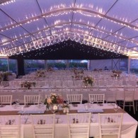 12m x 24m clear span marquee, unlined with fairy lights running along the roof and two bays of black LED star cloth.