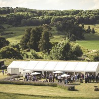 Marquee with people and hills in the background